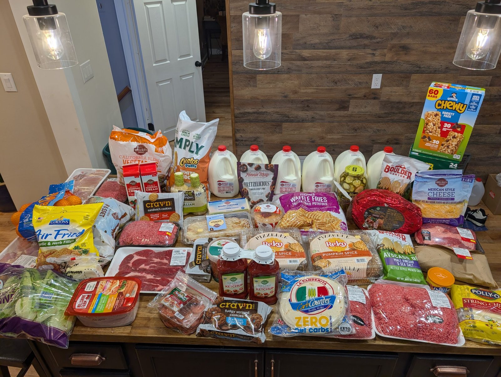 Massive December grocery haul overflowing on the kitchen island