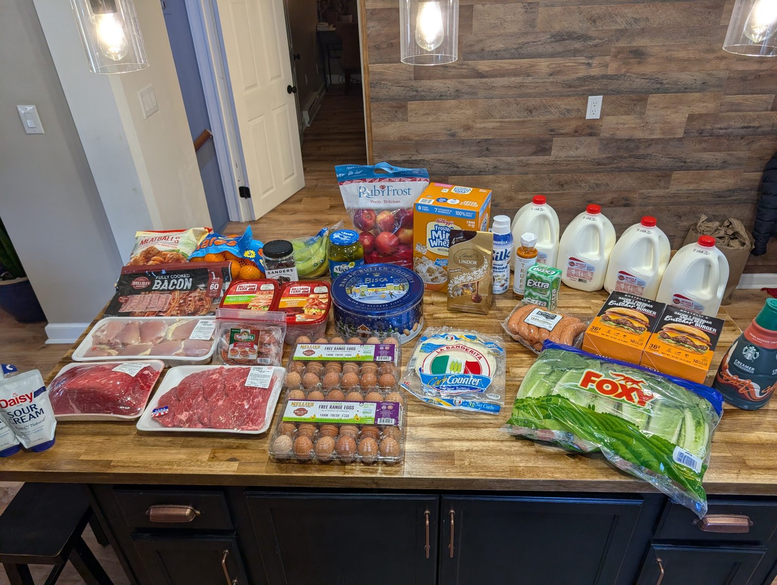 Massive December grocery haul overflowing on the kitchen island