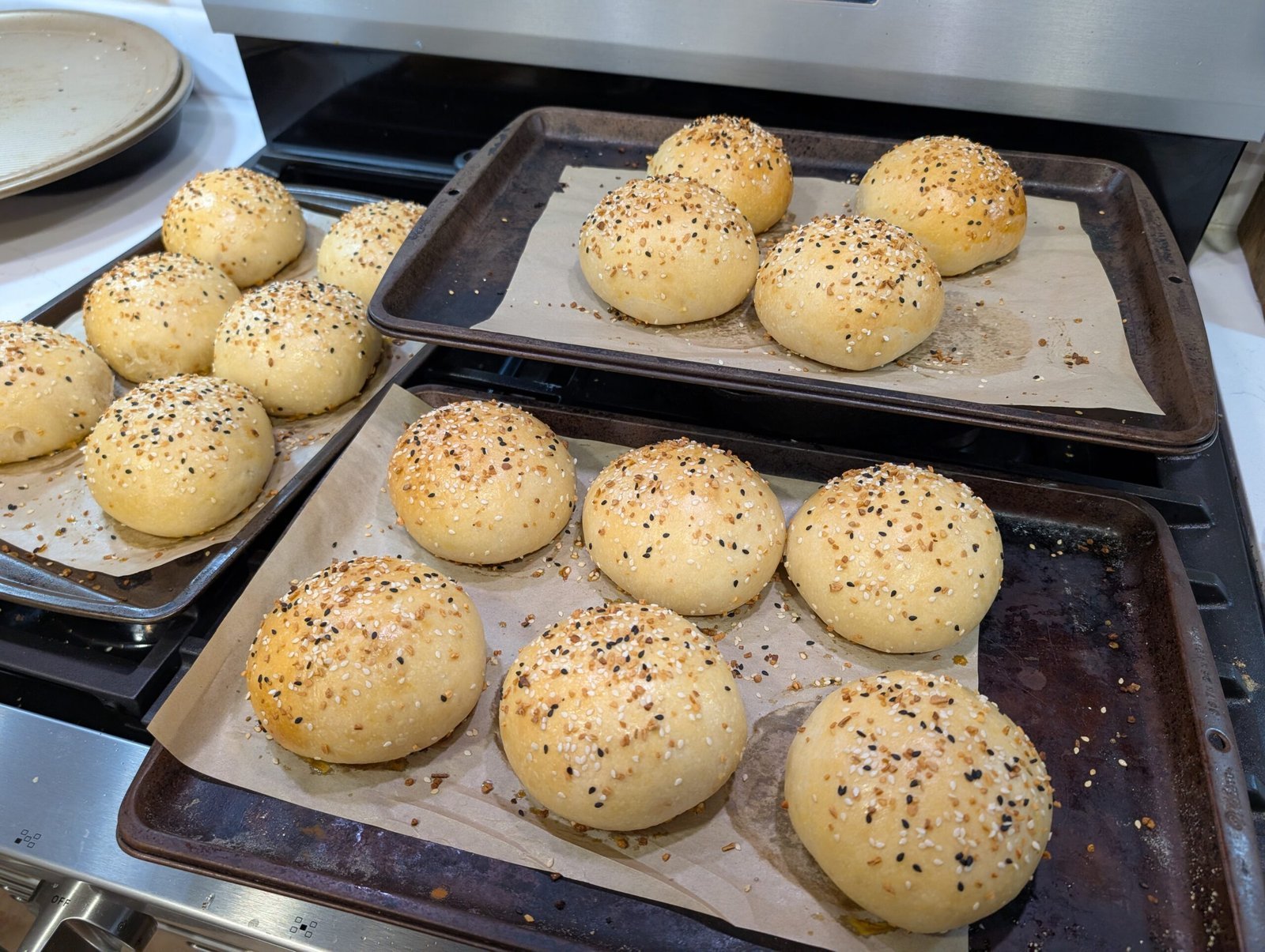 Freshly baked homemade sourdough hamburger buns on a cooling rack