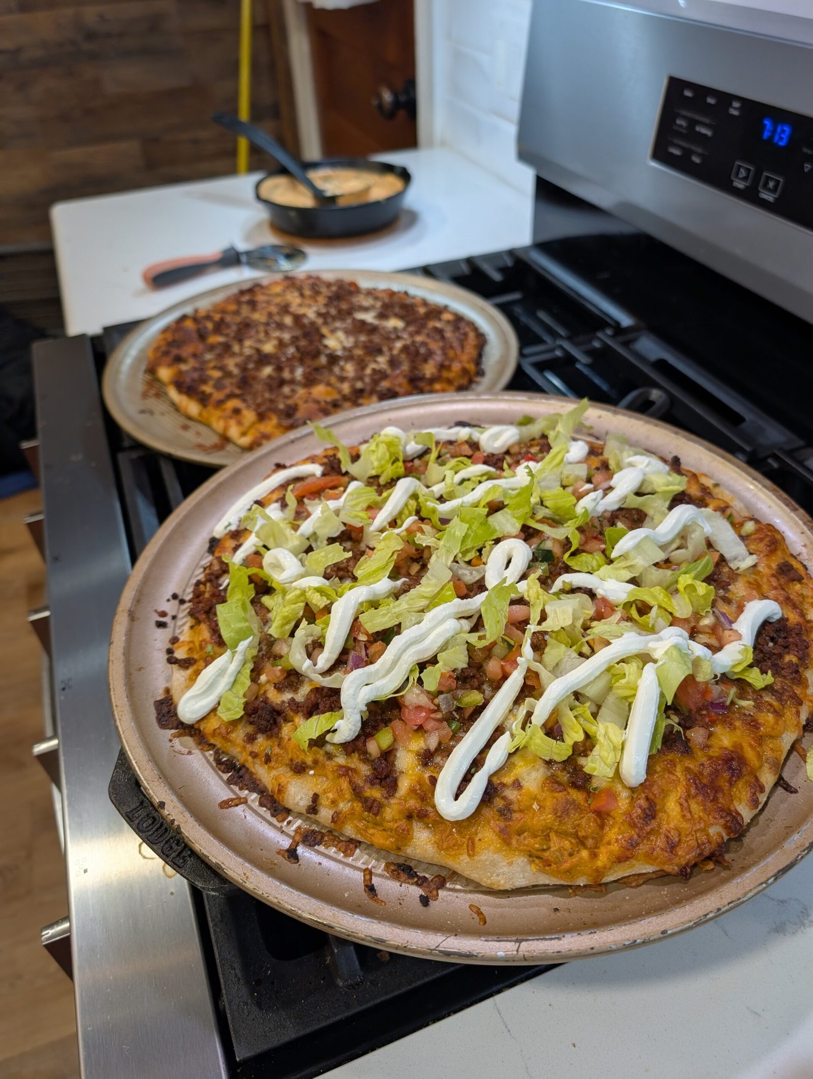 Freshly baked sourdough taco pizza with queso base and cold toppings